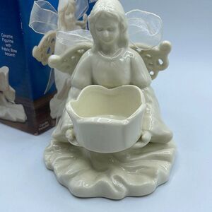 Ceramic angel tea light holder .